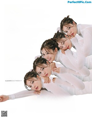 A woman in a white shirt and beige pants posing for a magazine.