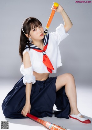 A woman in a blue and white outfit posing for a picture.