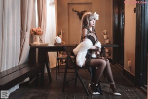 A woman in lingerie looking at herself in a mirror.