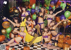 A group of women dressed in costumes posing for a picture.