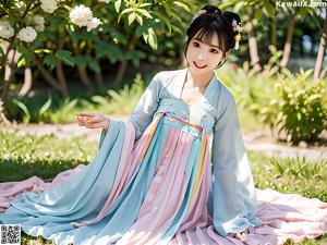 A woman in a pink and blue hanbok is posing for a picture.