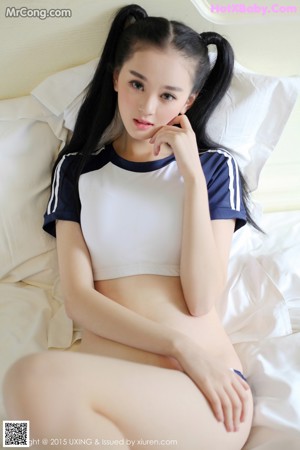 A woman in a sailor outfit laying on a bed.