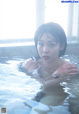 A person is washing their feet in the water.