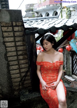 A woman in a white bra sitting at a table.