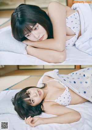 A woman sitting on top of a bed under a blanket.