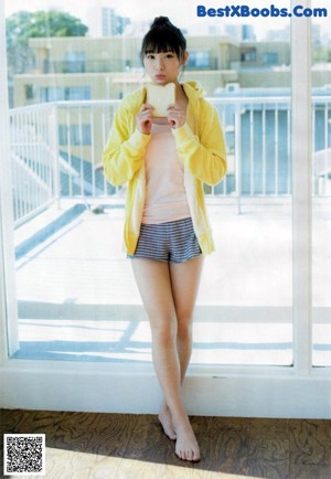 A woman in a white shirt and skirt posing for a picture.