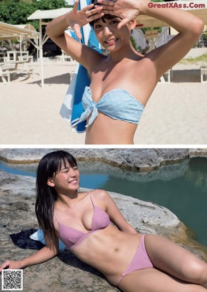 A woman sitting on a sandy beach next to a rock.