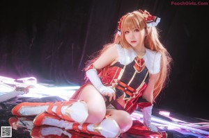 A woman in a red and white outfit holding a sword.