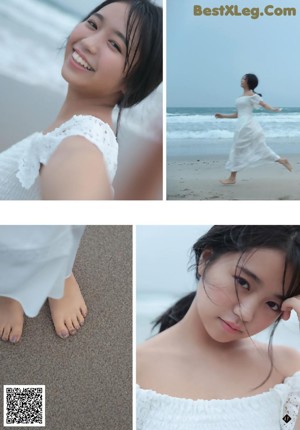 A woman wrapped up in a towel on the beach.