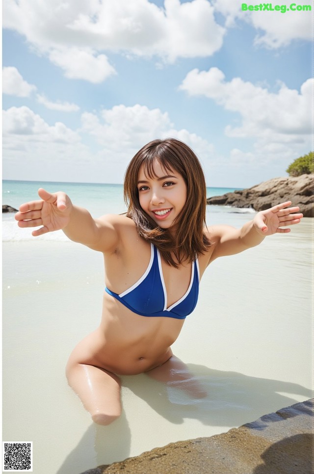 A woman in a blue bikini sitting in the water.