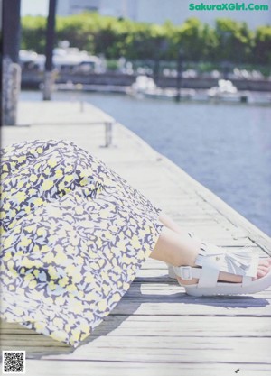 A magazine spread with a picture of a woman in a dress.