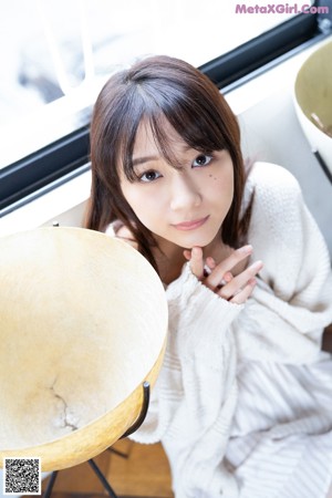 A woman laying on top of a white couch.