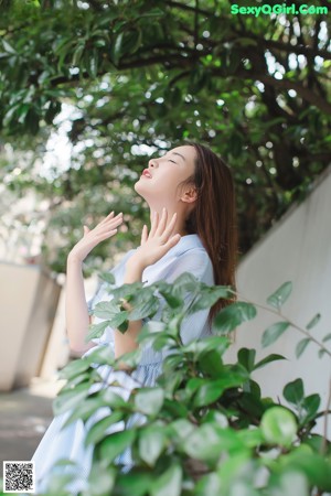 A woman holding a slice of watermelon in her hands.