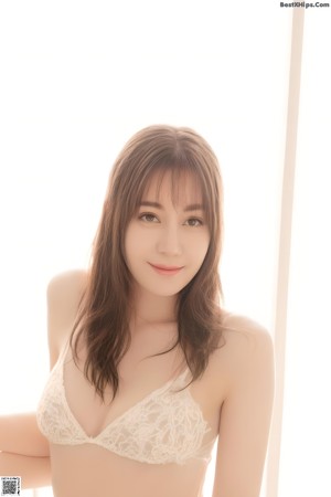 A woman in a white top and red skirt posing for a picture.