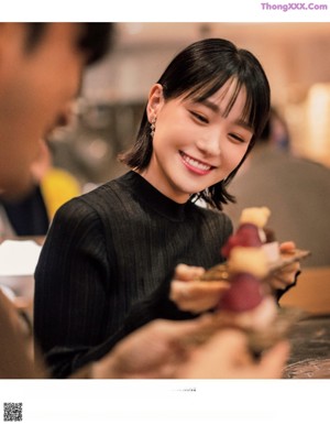 A man and a woman standing in a restaurant.