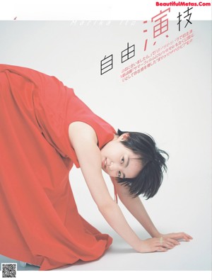 A woman in a red dress laying on the ground.