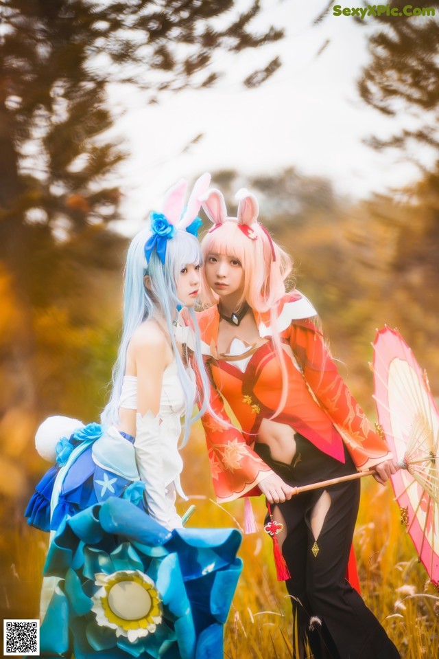 A couple of women dressed in costumes standing next to each other.